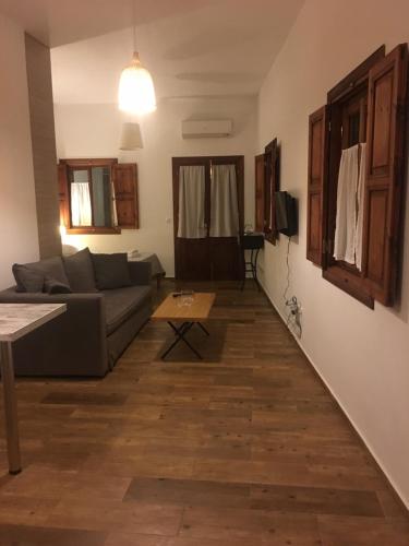 a living room with a couch and a table at Apocalypsis Houses in Skala