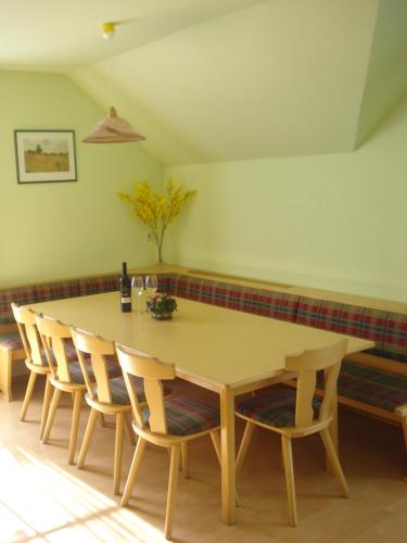 a dining room with a wooden table and chairs at Hansalagut in Mauterndorf