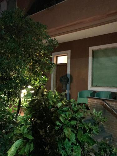 a house with a bush in front of a building at bellaria in Voghera