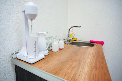 a kitchen counter with a white blender and a sink at Villa Beautiful in Gevgelija