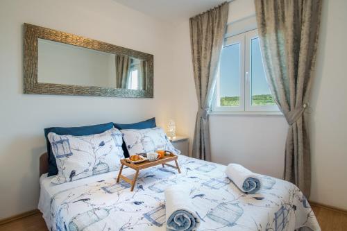 a bedroom with a bed with a table on it at Villa Daly in Primošten