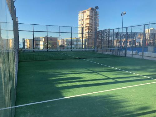 a tennis court in a city with buildings at Sunset Drive Vistas Magicas in Benidorm