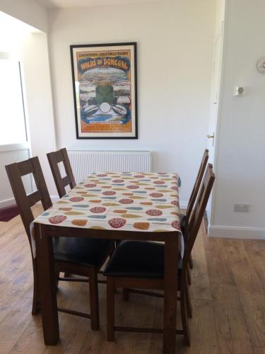 a dining room table with a table cloth on it at Annie's River Retreat in Doochary