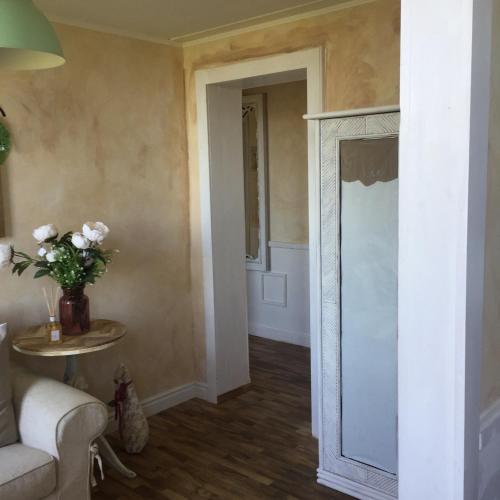 a living room with a couch and a mirror at Finestra sul verde in Siena