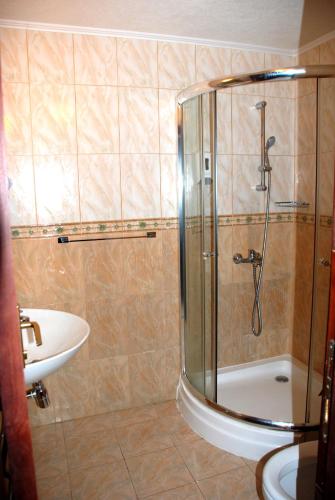 a bathroom with a shower and a sink at Elegant Lux Hotel in Bansko