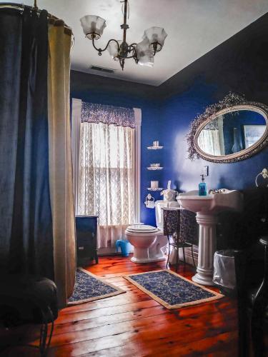 a bathroom with a toilet and a sink and a mirror at Innisfree Bed & Breakfast in South Bend