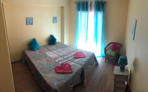 ポルティマンにあるCasa Aradeのベッドルーム1室(青い枕のベッド1台、窓付)