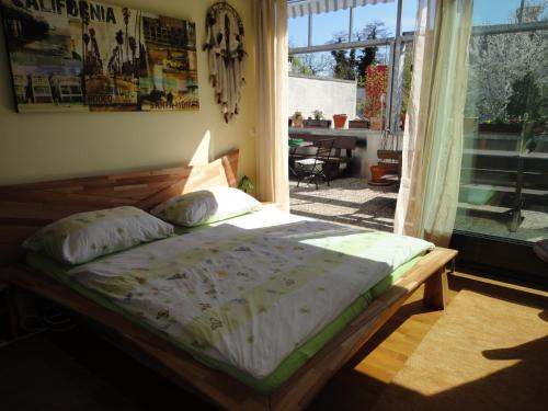 1 cama en un dormitorio con ventana en B & B Auf dem Wolf, St. Jakob en Basilea
