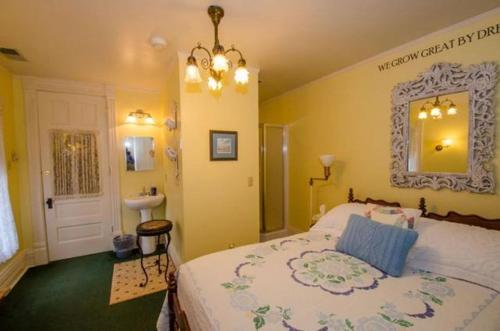a bedroom with a large bed and a sink at Innisfree Bed & Breakfast in South Bend