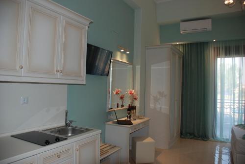 a kitchen with a sink and a sink at Elxis Luxury Resort in Nea Vrasna