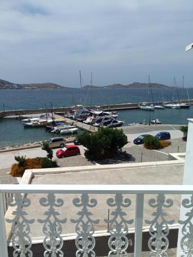 a balcony with a view of a marina with boats at Daphne in Naousa