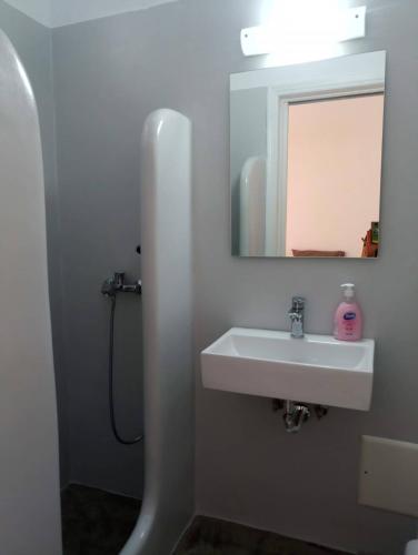 a bathroom with a sink and a mirror at Daphne in Naousa