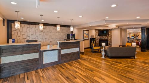 a lobby with a bar in a hotel at Best Western Plus North Joliet in Joliet