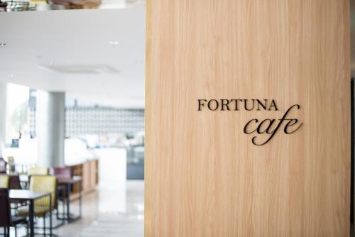a door with the words tortino cafe written on it at Fortuna Hotel in Tongyeong