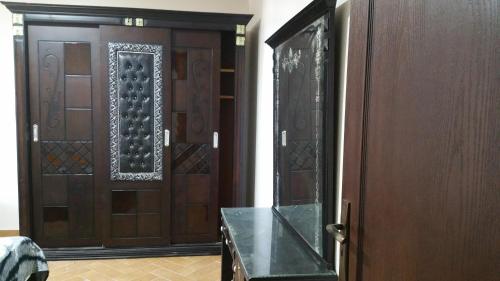 a room with a wooden door with a table in front at Stanley Bridge Apartment in Alexandria