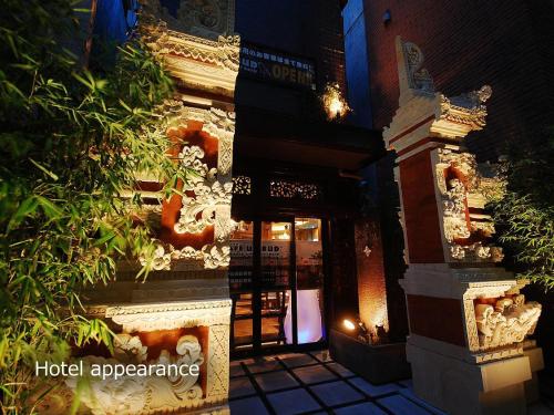 a hotel entrance with lights on the side of a building at Hotel BaliAn Resort Yokohama Kannai - Adult Only in Yokohama