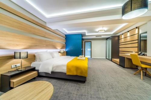 a hotel room with a bed and a desk at Unique - Resort and SPA in Ohrid