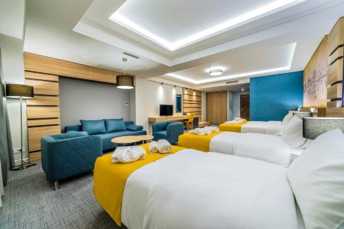 a hotel room with two beds and a chalkboard at Unique - Resort and SPA in Ohrid