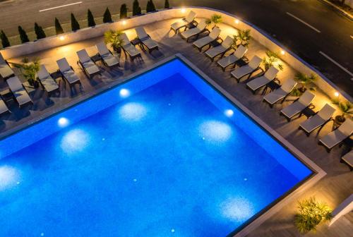 an overhead view of a large swimming pool with chairs at Unique - Resort and SPA in Ohrid