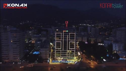 a night view of a city with a tall building at Konak seaside Tower-King's apartments in Mahmutlar