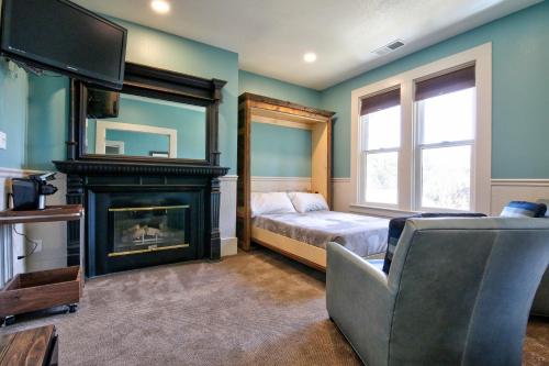a bedroom with a bed and a fireplace and a television at The Groveland Hotel in Groveland