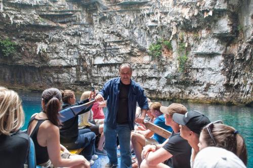 a man standing in front of a group of people on a boat at Evangelia in Ayia Evfimia