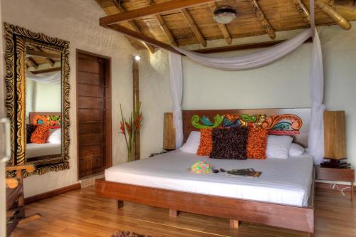 a bedroom with a large bed and a large window at Villa Maria Tayrona, a Kali Hotels in Los Naranjos