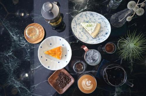 two plates of food on a table with desserts at NiHao Café Hotel in Taipei