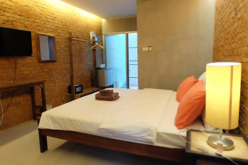 a bedroom with a bed with a fireplace and a television at The White Elephant Home in Chiang Mai