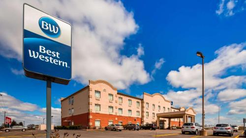 a best western sign in front of a building at Best Western Troy Hotel in Troy