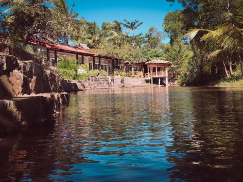 a view of a river with a building in the background at Bamboo Cottages in Phu Quoc