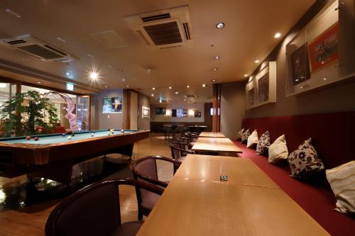 a row of tables in a bar with a pool table at Welco Narita in Narita
