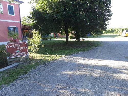 a sign on the side of a road next to a building at Barone Rosso in Treviso