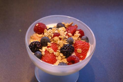 a plastic bowl of fruit salad with nuts and berries at Alpenglow Bed and Breakfast in Kimberley