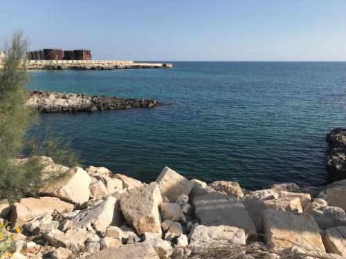 a view of a body of water with rocks at Il Mare di Giò in Monopoli