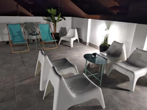 a group of chairs and tables in a room at Soléa House Hotel Boutique in Benicàssim