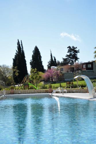 a swimming pool with a bridge over the water at Droushia Heights Hotel in Droushia