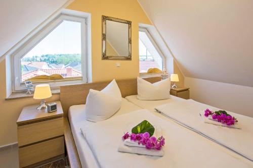 a bedroom with two beds with flowers on them at Villa Europa in Heringsdorf