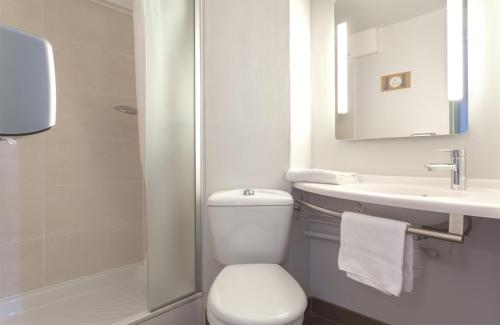 a bathroom with a toilet and a sink and a shower at B&B HOTEL CHAMBERY La Cassine in Chambéry