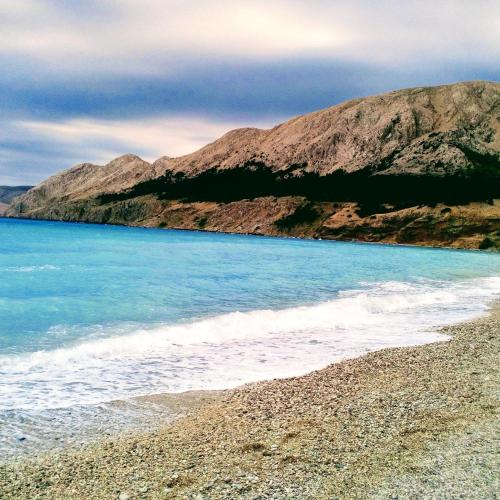 a view of a beach with mountains in the background at Lavender in Baška