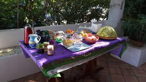 a purple table with food and other items on it at Agriturismo La Dolce Vita Lipari in Lipari