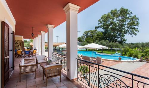 a balcony with a view of a swimming pool at Aneli Luxury Villas-Villa Anastasia in Ayios Kirikos