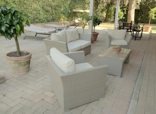 a patio with couches and chairs and a table at LAGO GABBIANO PODERe CASANOVA in Pistoia