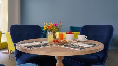 a table with a tray of food and flowers on it at Hotel LaMorosa in Rimini