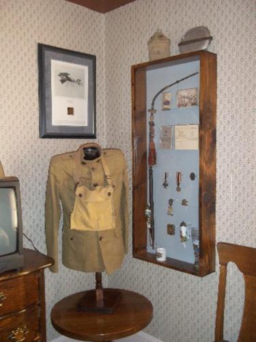 a mirror on a wall with a jacket on a table at A Sentimental Journey in Gettysburg
