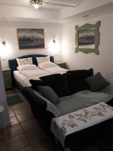 a living room with two beds and a couch at Pletna Lake View Apartment (Ground Floor) in Bled