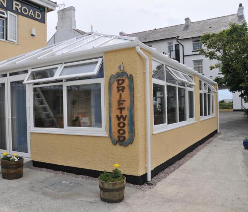 a building with a sign on the side of it at The Beach Motel in Trearddur