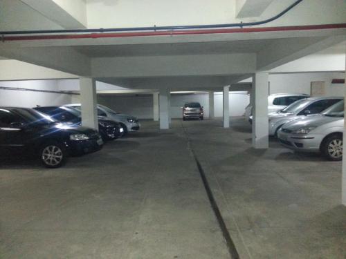 a parking garage with cars parked in it at Hotel Doce Mar in Búzios