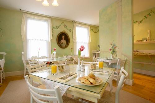 a dining room with a table with a plate of bread at Admiral Fitzroy Inn in Newport