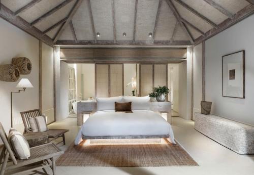 a bedroom with a large bed and a desk at Raya Heritage - SHA Plus in Chiang Mai